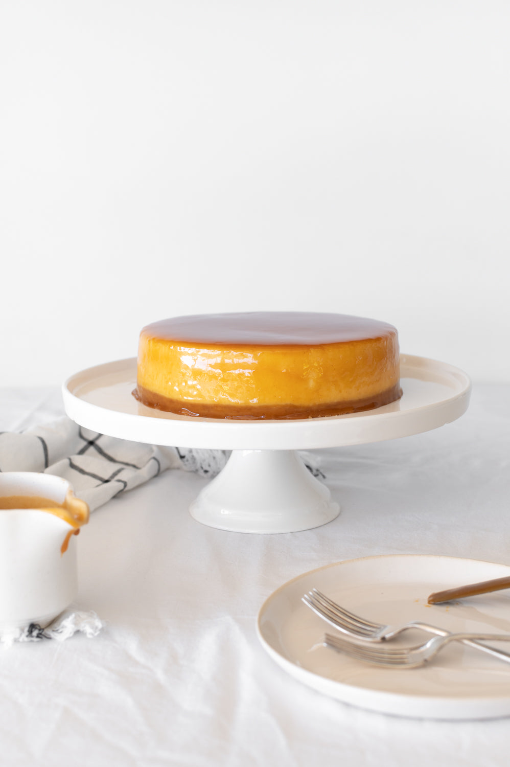 Salted Butter Caramel glazed Baked Cheesecake on a cake stand
