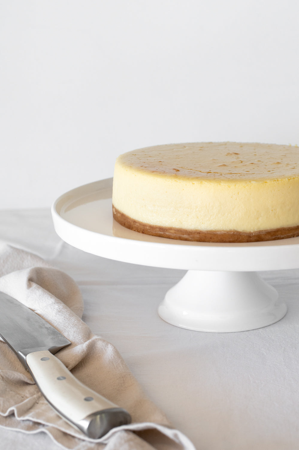 Plain Baked Cheesecake on a cake stand