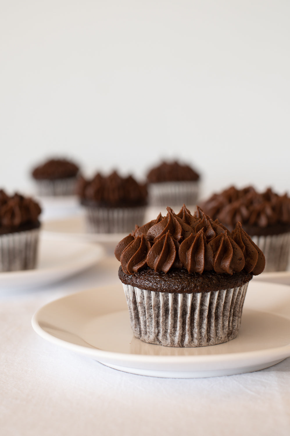Several chocolate cupcake with chocolate buttercream piped on top 