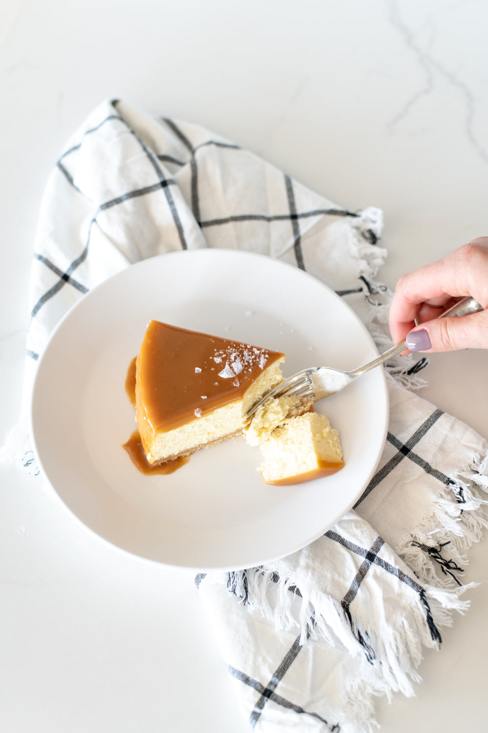 A top view of a slice of salted Butter Caramel glazed Baked Cheesecake 