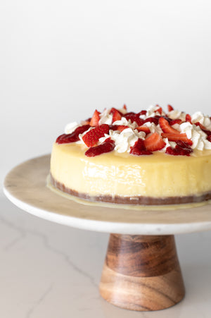 Strawberries and Cream Baked Cheesecake on a cake stand
