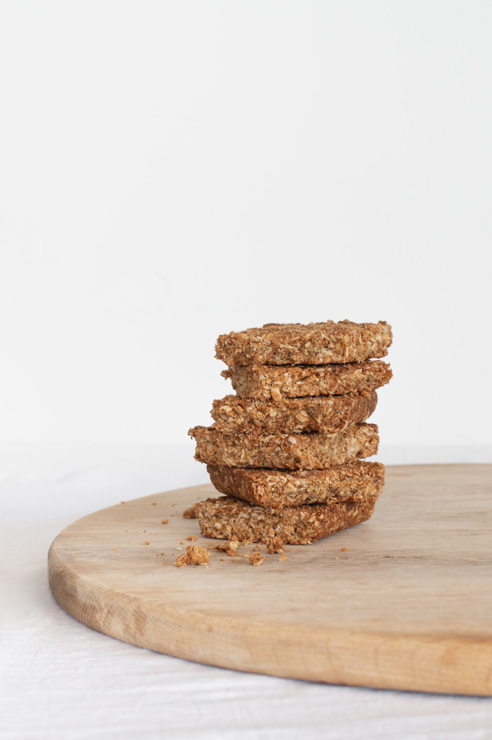 A stack of oat crunchies on a wooden board