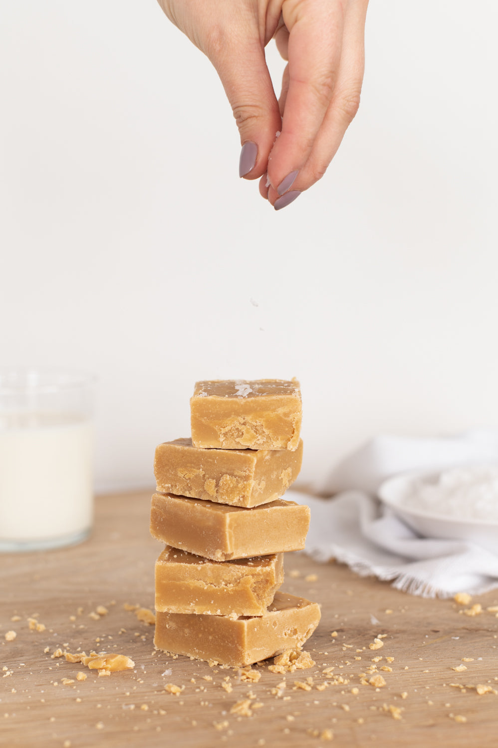 A stack of Salted Caramel Fudge on a wooden board