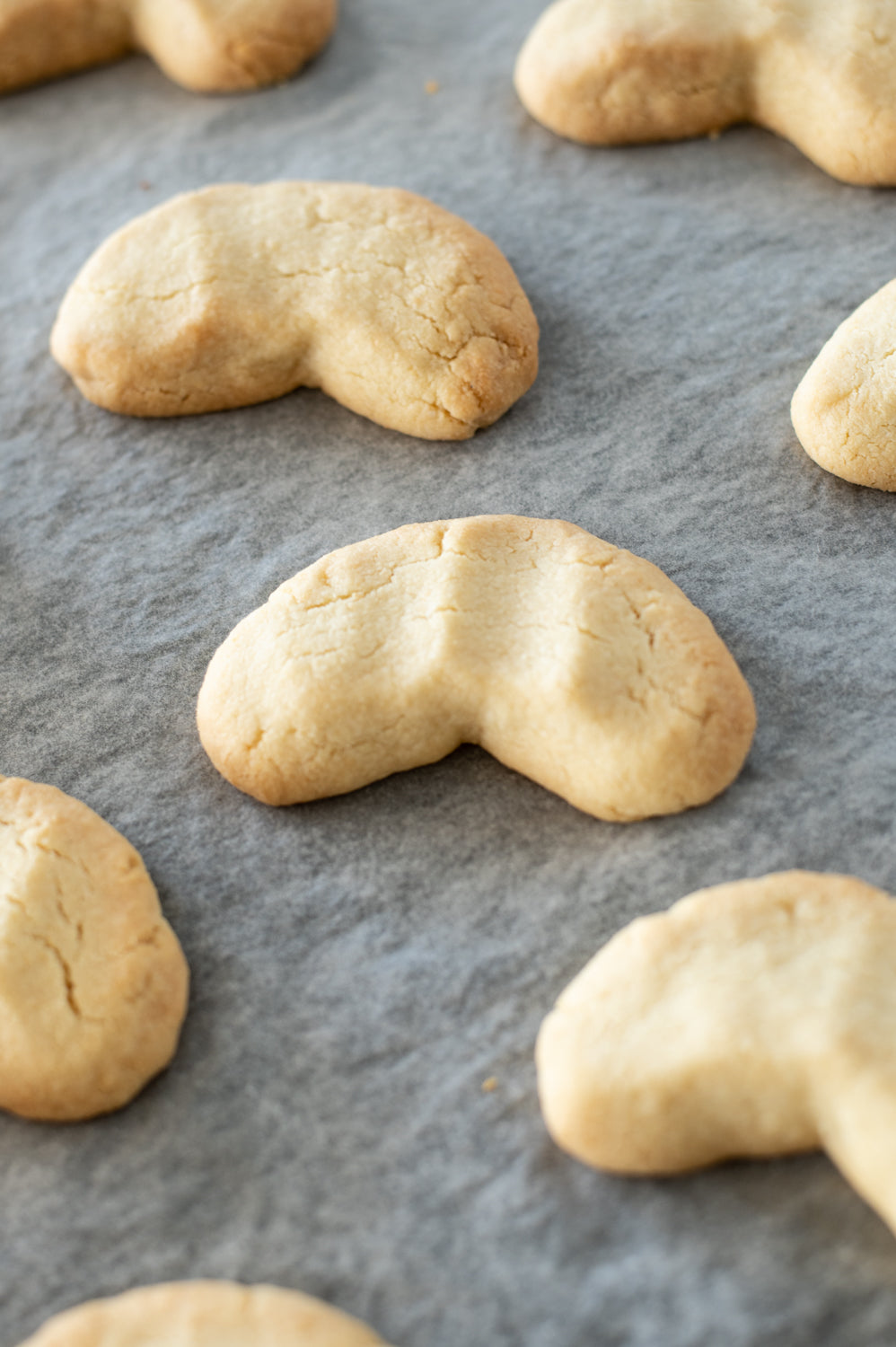 Crescent shaped cookies on a baking tray