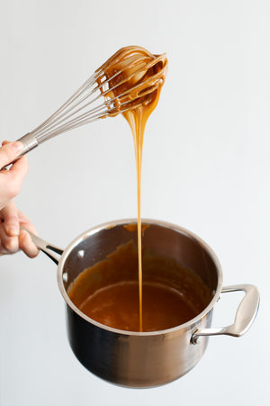Pot of caramel with a whisk